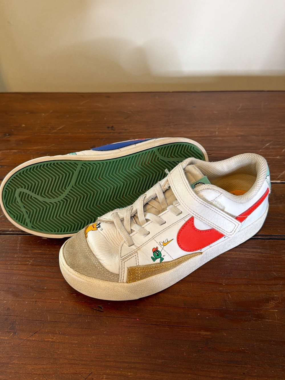 Nike Kids White Sneakers with Red Swoosh and Green Sole